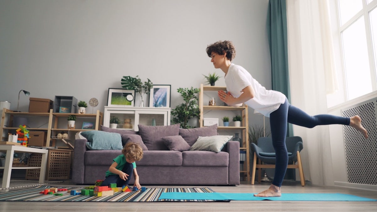 a woman and a child playing in a living room